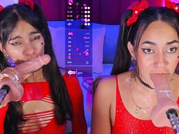Two sexy brunettes suck a dildo