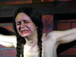 Another sobbing drooling slave cunt hangs from the cross in hopeless stretched agony